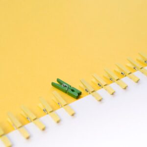 green-clothespin-surrounded-by-yellow-ones_23-2148476837